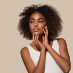 beautiful african woman white t shirt portrait afro haircut touching her face color background brown 431835 12160